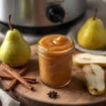 jars of homemade pear butter with cinnamon sticks and fresh pears