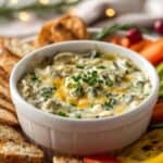 Close-up of creamy spinach artichoke dip with melted mozzarella on top