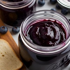 Canned blueberry butter jars on a kitchen counter
