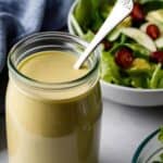 Homemade ginger miso salad dressing with sesame oil and fresh ginger on wooden table