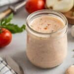 A bowl of light Russian dressing served with fresh vegetable crudités for dipping.