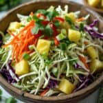 Close-up of Caribbean coleslaw with colorful veggies and tropical flavors.