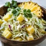 Close-up of vibrant pineapple coleslaw with colorful cabbage and pineapple chunks