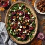 Beet salad with goat cheese, nuts, and arugula on a holiday table.