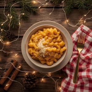 bowl of creamy butternut squash mac and cheese topped with breadcrumbs