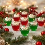 Red and green layered Christmas jello shots in festive cups