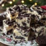 Festive Oreo fudge squares stacked on a holiday-themed plate
